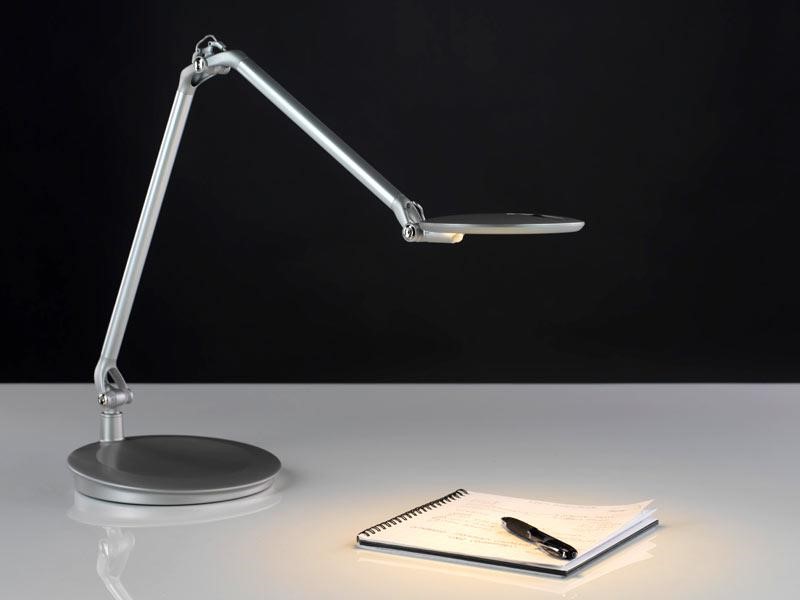 A desk light, notebook and pen